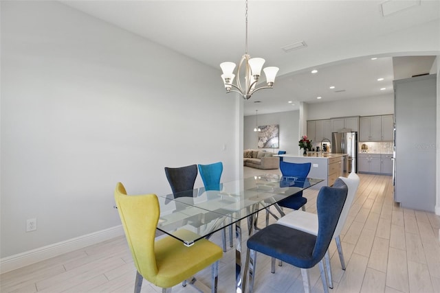 dining space with light wood-style floors, recessed lighting, a chandelier, and visible vents