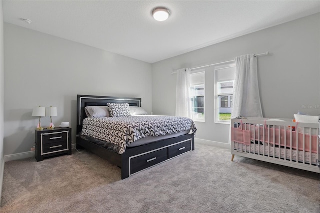 carpeted bedroom with baseboards