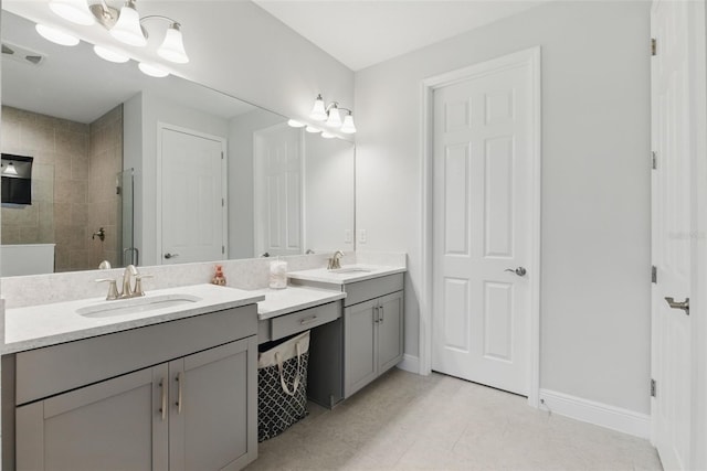 bathroom featuring a chandelier, vanity, visible vents, baseboards, and a stall shower