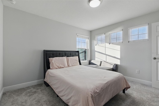 carpeted bedroom with baseboards