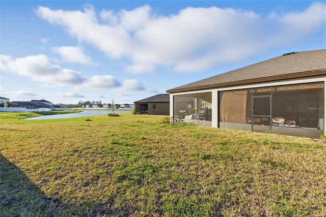 view of yard with a water view and a sunroom