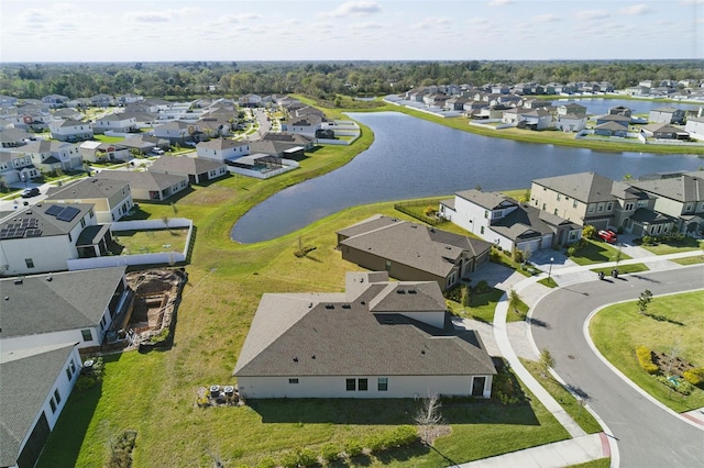 drone / aerial view featuring a residential view and a water view