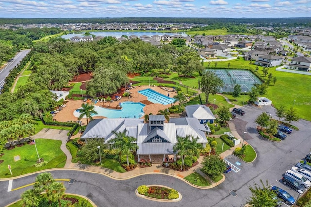 drone / aerial view featuring a residential view and a water view