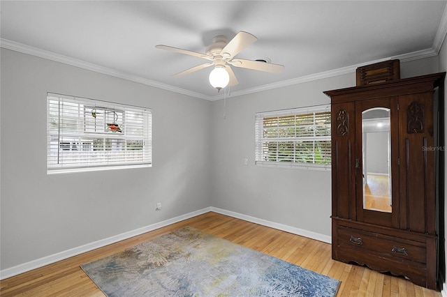 unfurnished room featuring ceiling fan, ornamental molding, and light hardwood / wood-style flooring