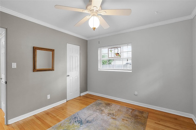 bedroom featuring crown molding, hardwood / wood-style flooring, and ceiling fan