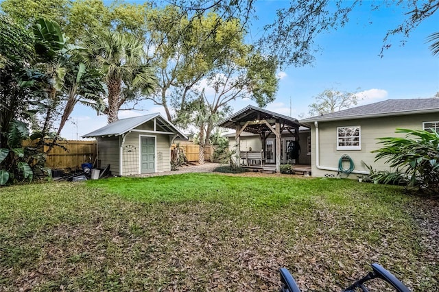 view of yard with a gazebo and a storage unit