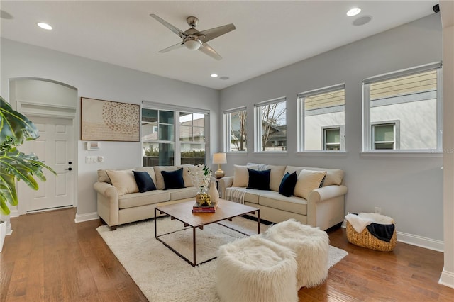 living room with recessed lighting, baseboards, and wood finished floors