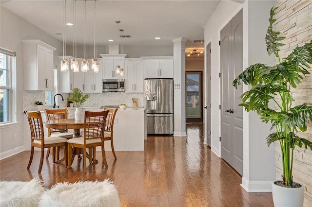 dining area featuring recessed lighting, visible vents, baseboards, and wood finished floors