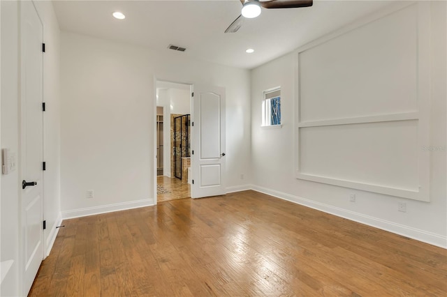 unfurnished bedroom with recessed lighting, wood finished floors, visible vents, and baseboards