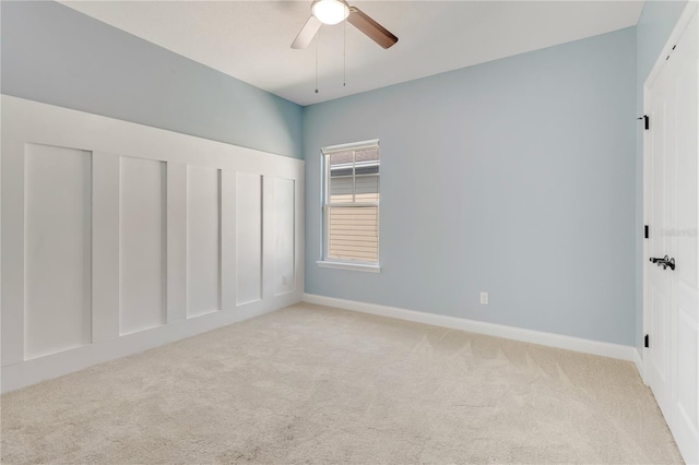 unfurnished bedroom with light carpet, a ceiling fan, and baseboards