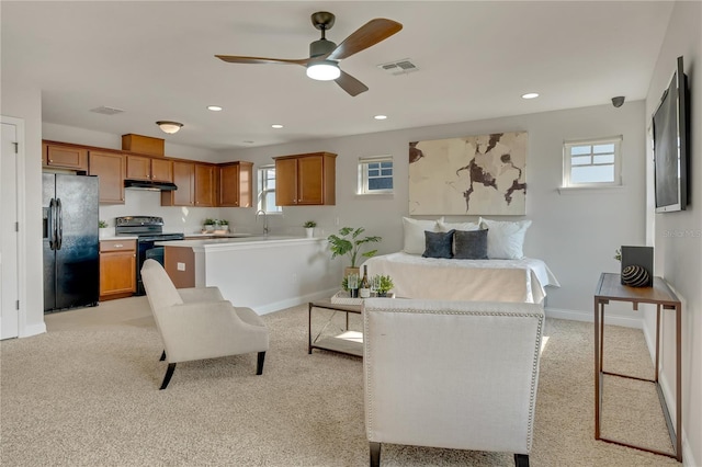 living area featuring baseboards, recessed lighting, visible vents, and light colored carpet