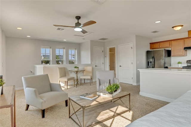 living area with light carpet, baseboards, visible vents, and recessed lighting