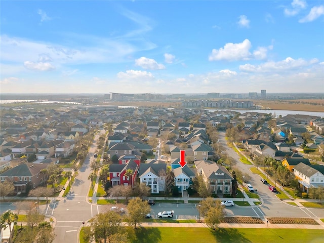 birds eye view of property with a water view and a residential view