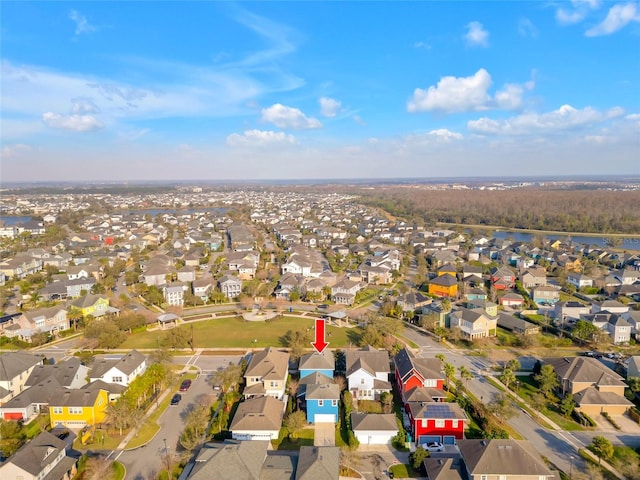 drone / aerial view featuring a water view and a residential view