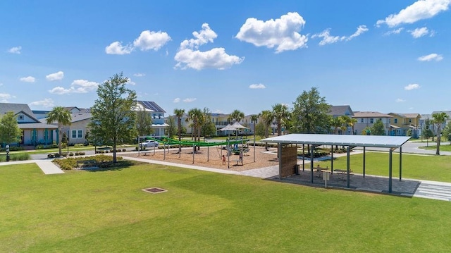 view of community with a residential view, playground community, and a yard