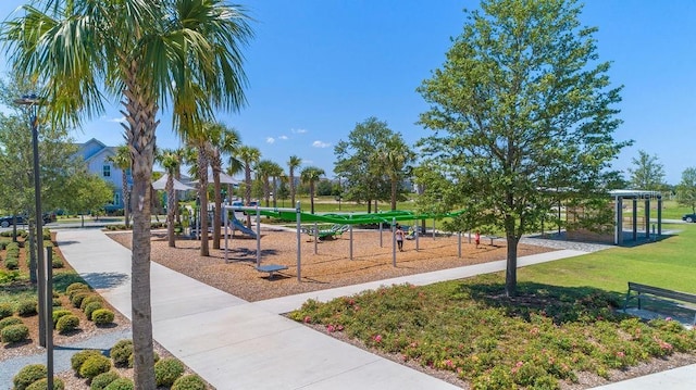 community playground featuring a pergola and a lawn