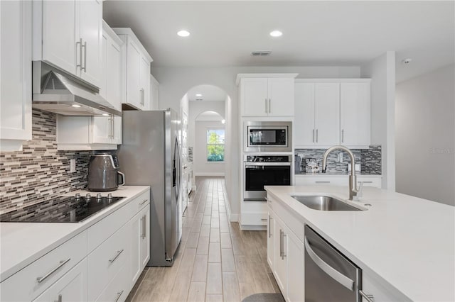 kitchen featuring white cabinetry, sink, tasteful backsplash, and appliances with stainless steel finishes