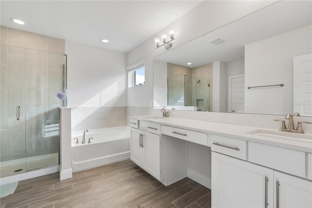 bathroom with vanity and separate shower and tub