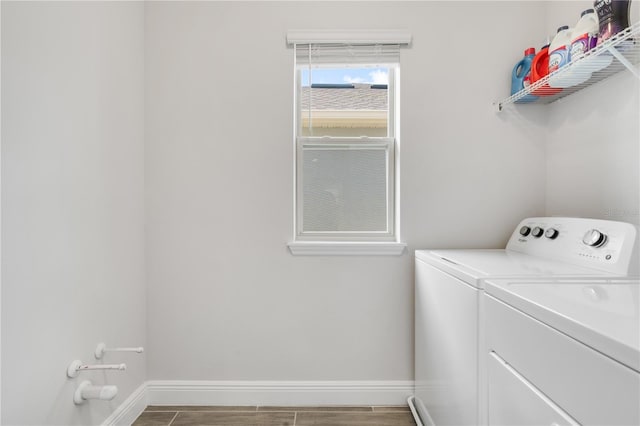 washroom with wood-type flooring and washer and clothes dryer