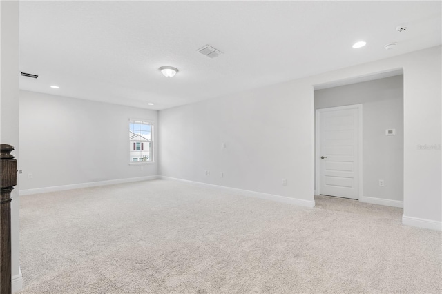 spare room featuring light colored carpet