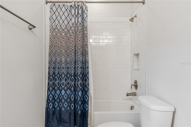 bathroom featuring shower / tub combo with curtain and toilet