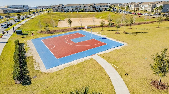 view of sport court with a lawn