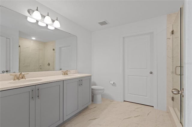 bathroom featuring vanity, toilet, and walk in shower