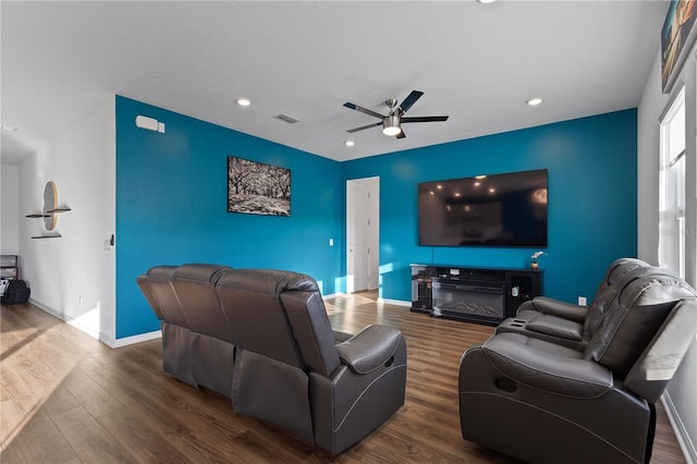 living room featuring dark hardwood / wood-style floors and ceiling fan