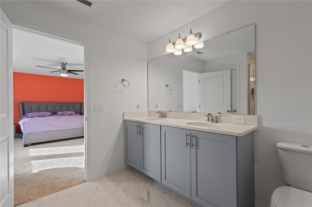 bathroom featuring ceiling fan, vanity, and toilet