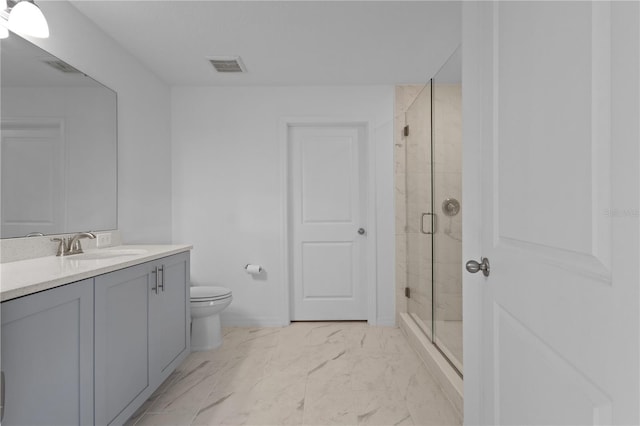 bathroom featuring vanity, toilet, and walk in shower