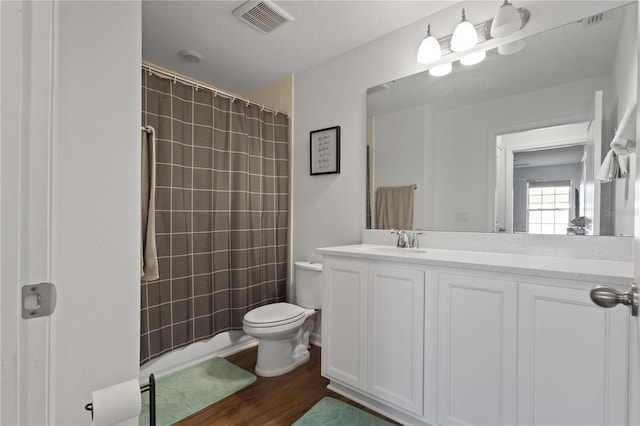 bathroom featuring vanity, curtained shower, wood-type flooring, and toilet