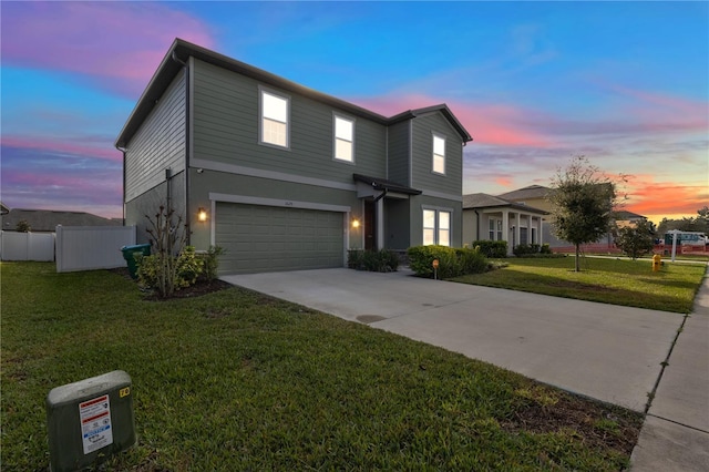 view of front of home with a garage and a lawn