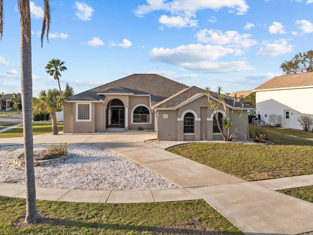 mediterranean / spanish-style home featuring a front yard