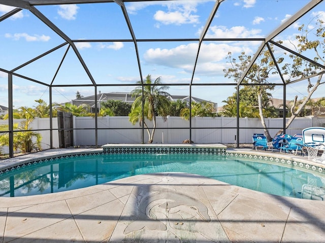 view of pool with a patio area and a lanai