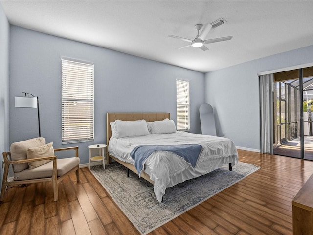 bedroom with multiple windows, access to exterior, ceiling fan, and wood-type flooring