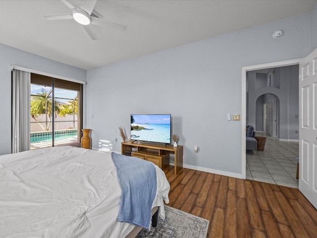 bedroom featuring ceiling fan, wood-type flooring, and access to outside