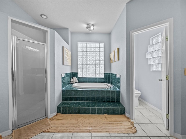 bathroom featuring separate shower and tub, a textured ceiling, toilet, and tile patterned floors