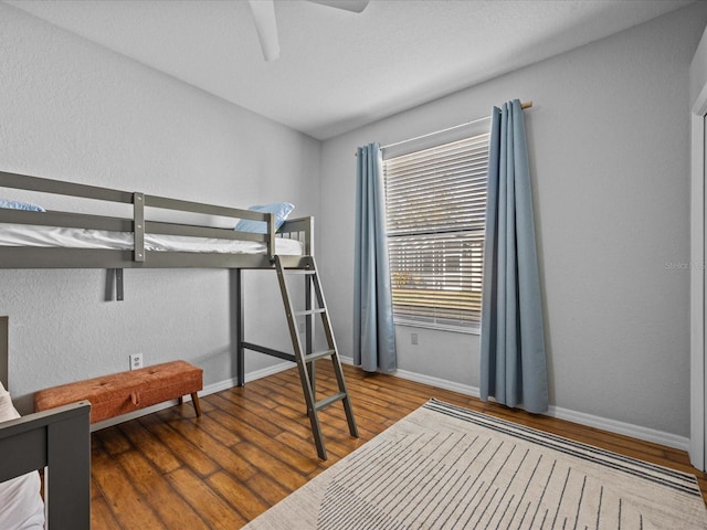 bedroom featuring ceiling fan and dark wood-type flooring