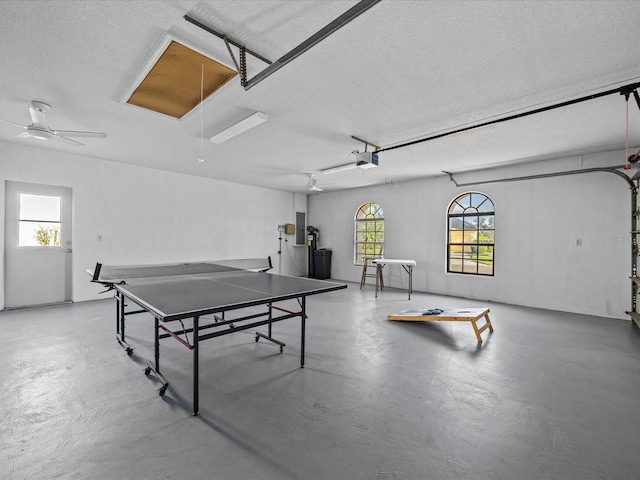 playroom with concrete flooring, plenty of natural light, and a textured ceiling