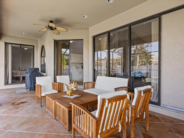 view of patio with ceiling fan and area for grilling