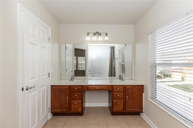 bathroom featuring tile patterned flooring, vanity, and walk in shower