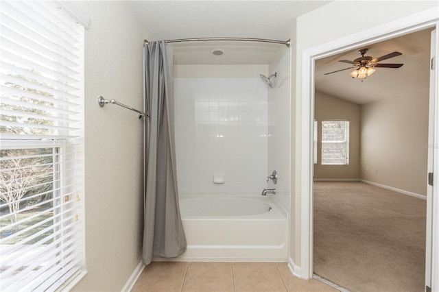 bathroom with shower / tub combo, ceiling fan, lofted ceiling, and tile patterned flooring