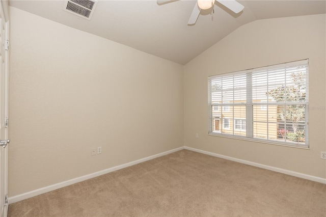 carpeted spare room with vaulted ceiling and ceiling fan