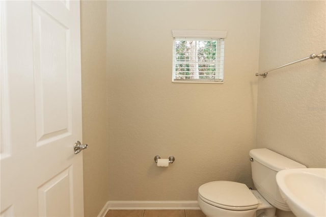 bathroom with tile patterned flooring, sink, and toilet