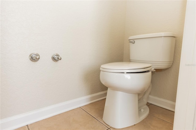 bathroom with tile patterned flooring and toilet