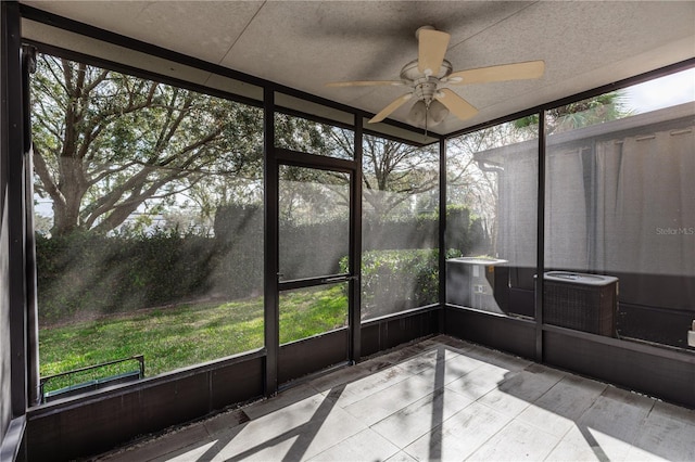 unfurnished sunroom with ceiling fan