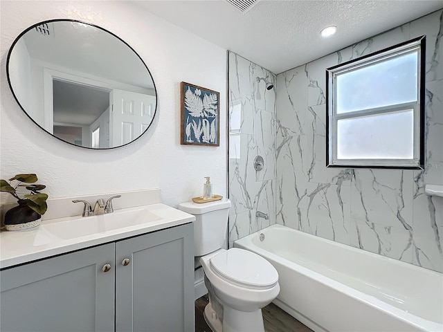 full bathroom featuring toilet, tiled shower / bath, a textured ceiling, vanity, and hardwood / wood-style floors