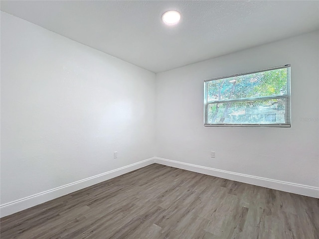 spare room with hardwood / wood-style floors