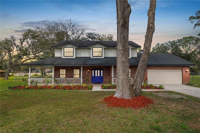 view of front of home with a porch, brick siding, and a lawn