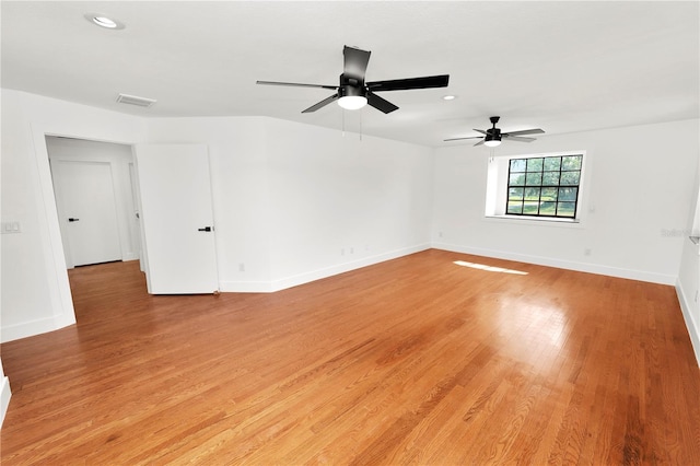 unfurnished room with recessed lighting, light wood-type flooring, visible vents, and baseboards